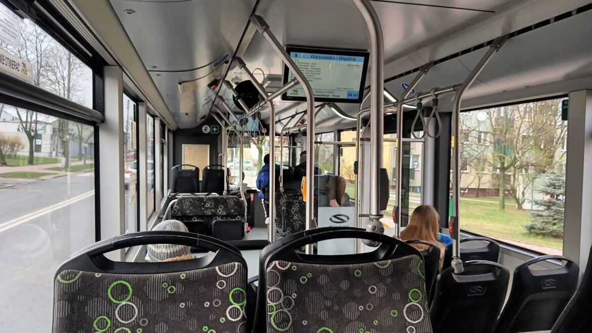 the interior of a public transit bus with passengers